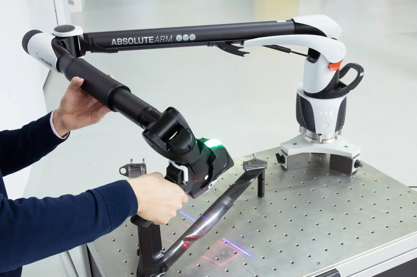 Absolute Arm med AS1-laserskanner som skanner en sykkelramme i karbon på et målebord